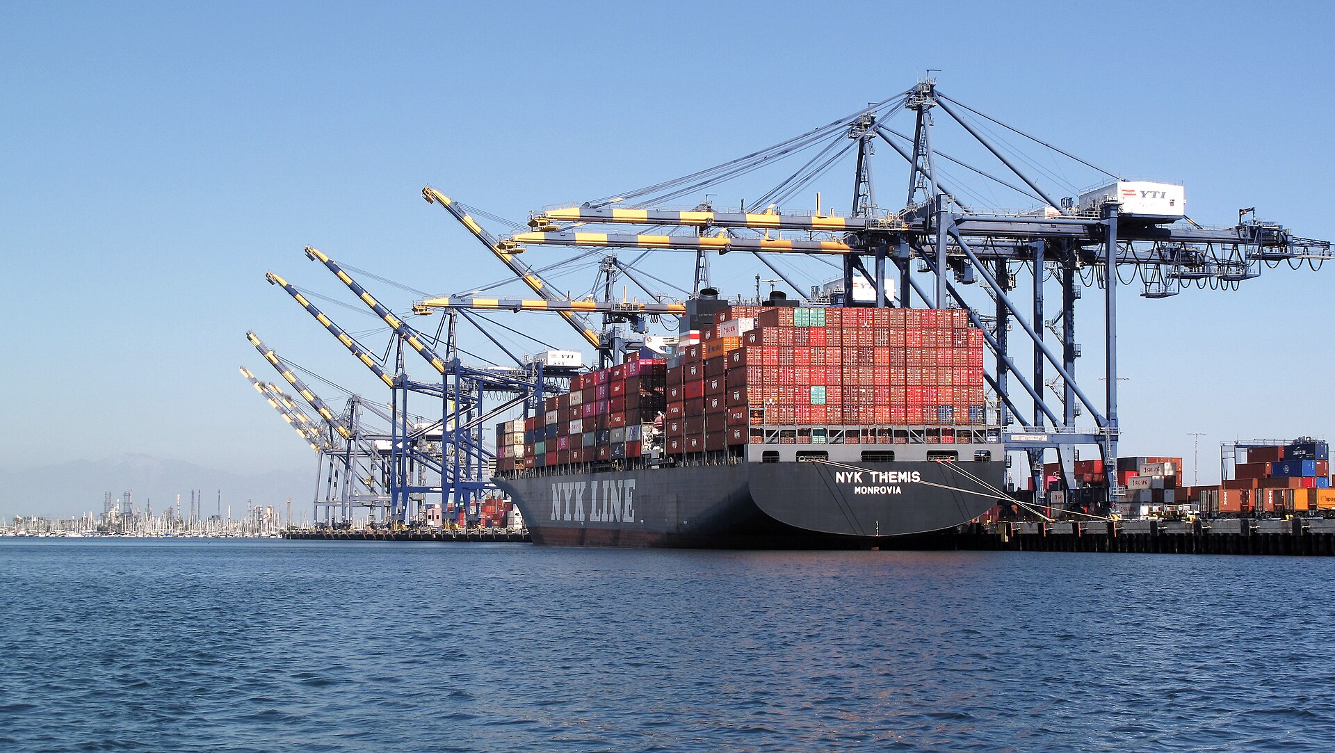 Container ship docked at the Port of Los Angeles under gantry cranes